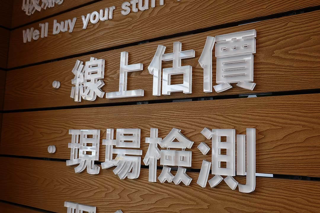 收購手機 – iPhone 與 Android 舊機換現金,全台實體門市高價回收 - 第2張圖 青蘋果3C門市木紋牆面,展示「線上估價、現場檢測」字樣服務流程